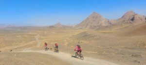 Cycling through a spectacular mountain vista in Uzbekistan