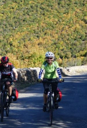 Two Ladies cycling a road in Albania