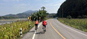Cyclists on a road in Northern Thailand near the border with Laos